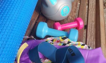 Photo of a selection of fitness equipment on a park bench